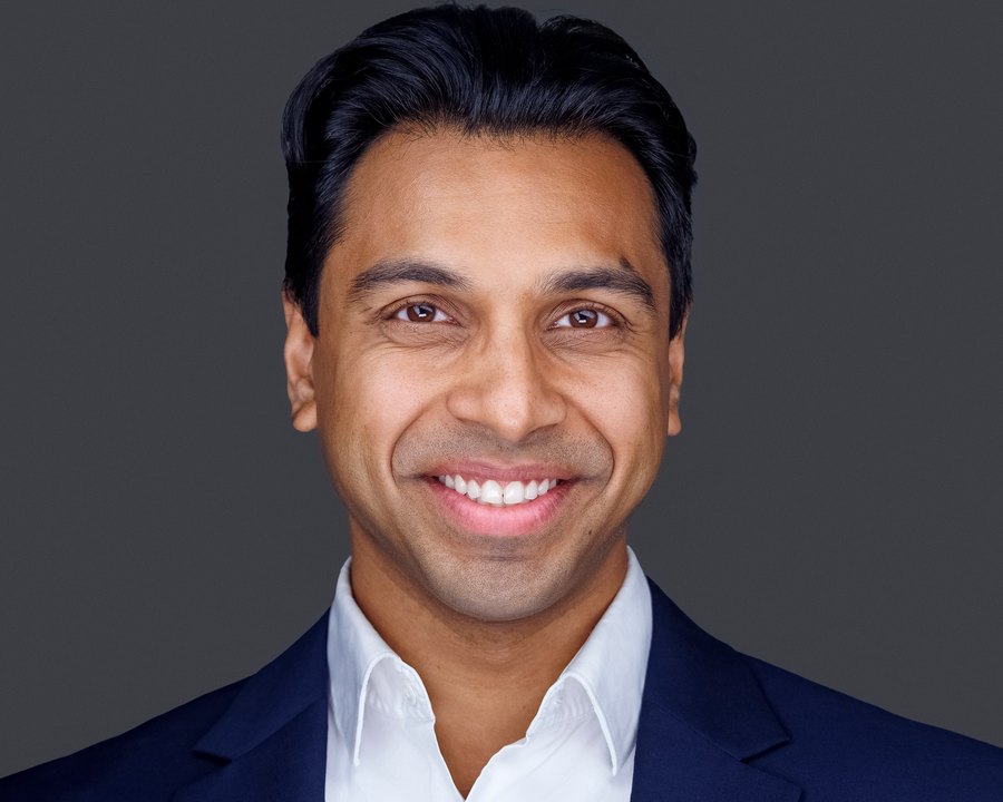 Corporate headshot on a charcoal background