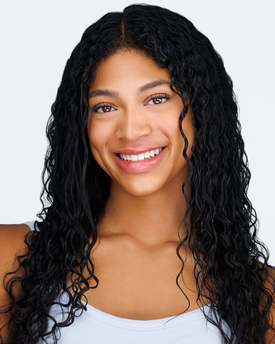 Bright, natural headshot with a warm smile